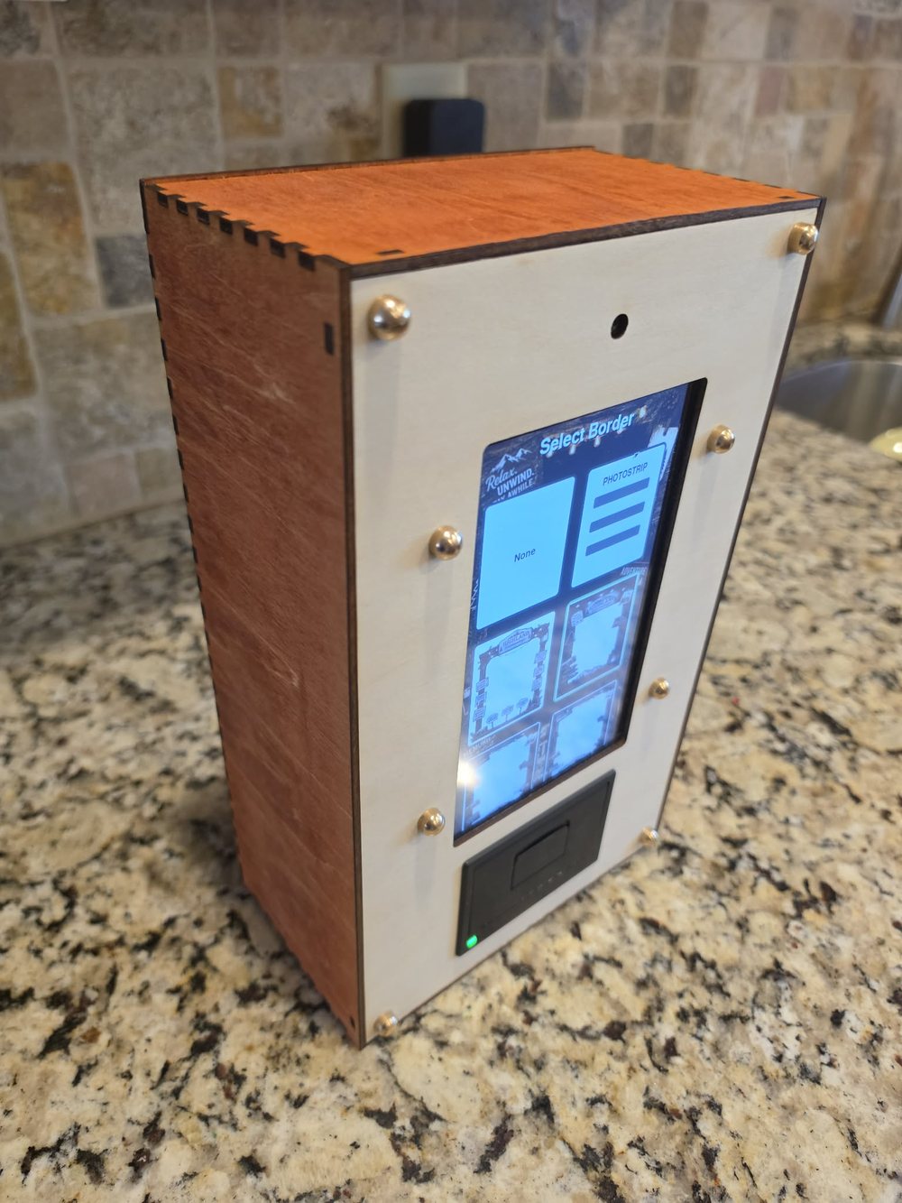 Paperbooth unit, angled view showing the wood side panel and top