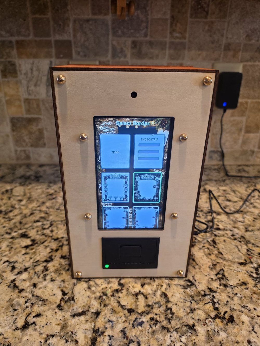 Paperbooth unit, front view, showing the touchscreen border-selection menu